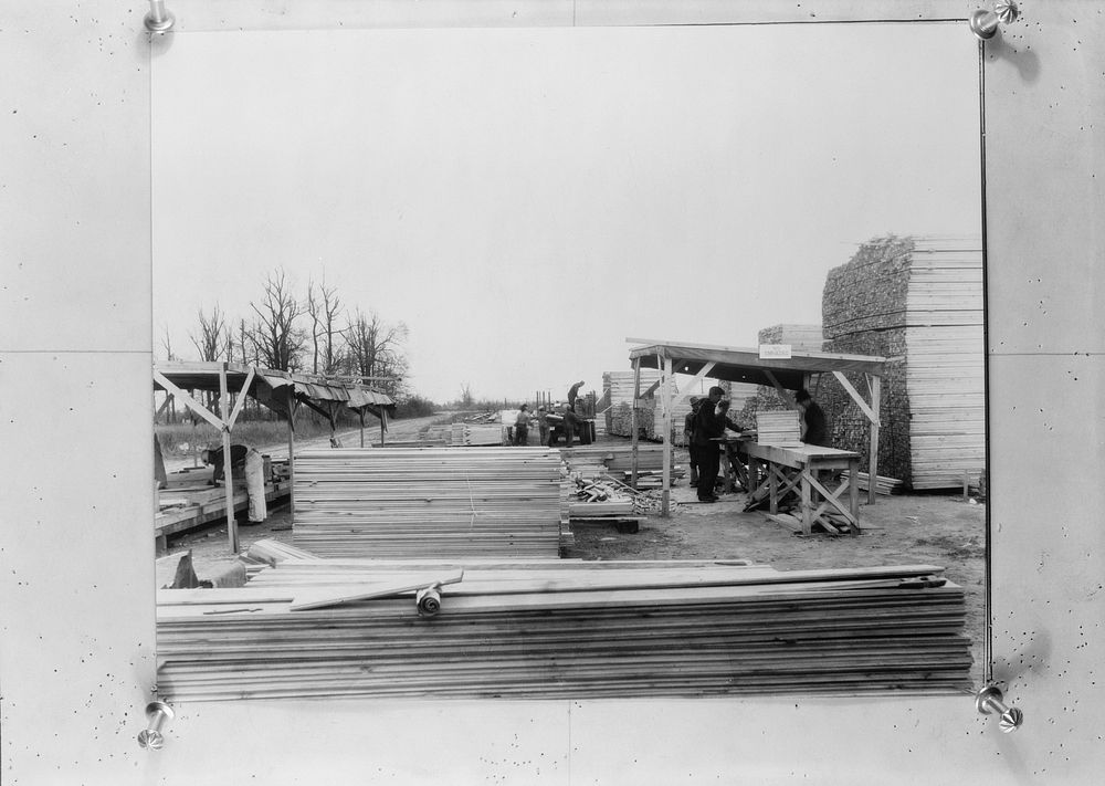 Lumber being pre-cut preparatory to nailing in sections. Prefabricated construction at La Forge project, Missouri by Russell…