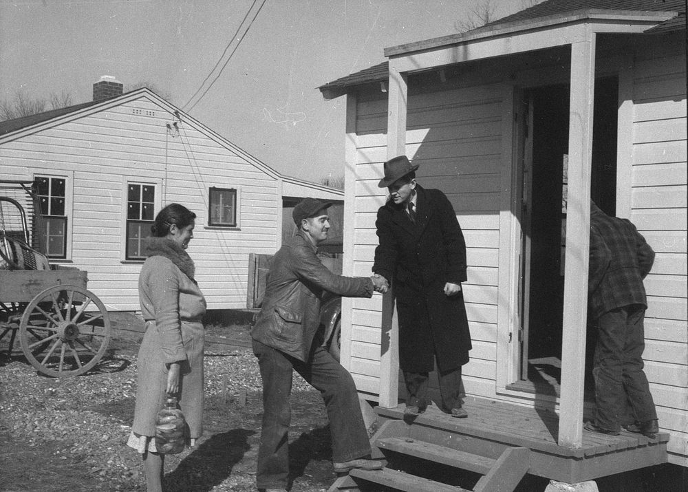 Carl O. Hudson, camp manager, welcomes Wicker family to new home. Southeast Missouri. Sourced from the Library of Congress.