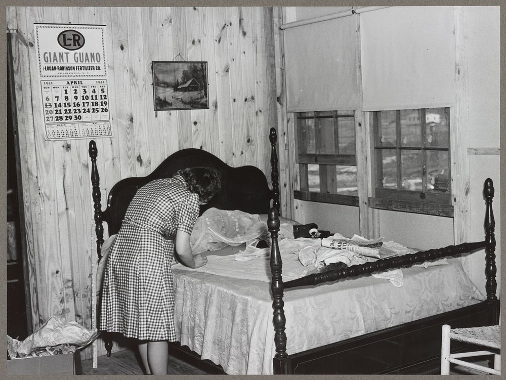 Fixing the curtains to be hung in their new prefabricated house at the home of the Hodge family. Pacolet, South Carolina.…