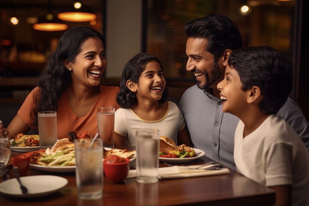 Restaurant eating laughing family. 