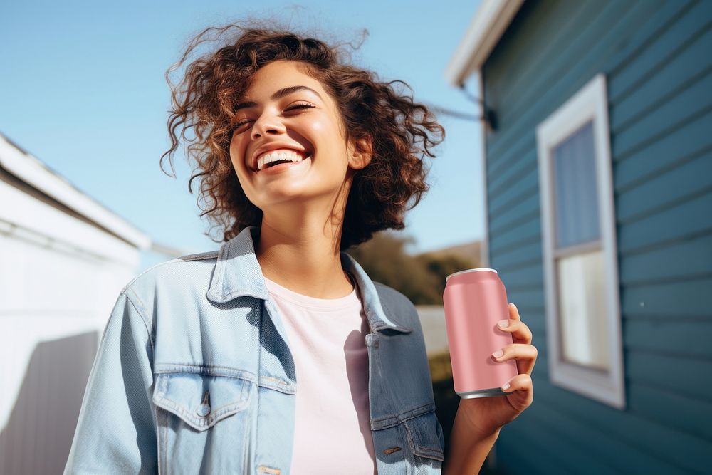 Happy woman holding soda can
