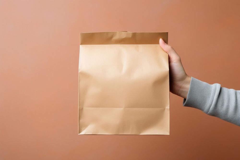 Bag holding paper hand. AI generated Image by rawpixel.