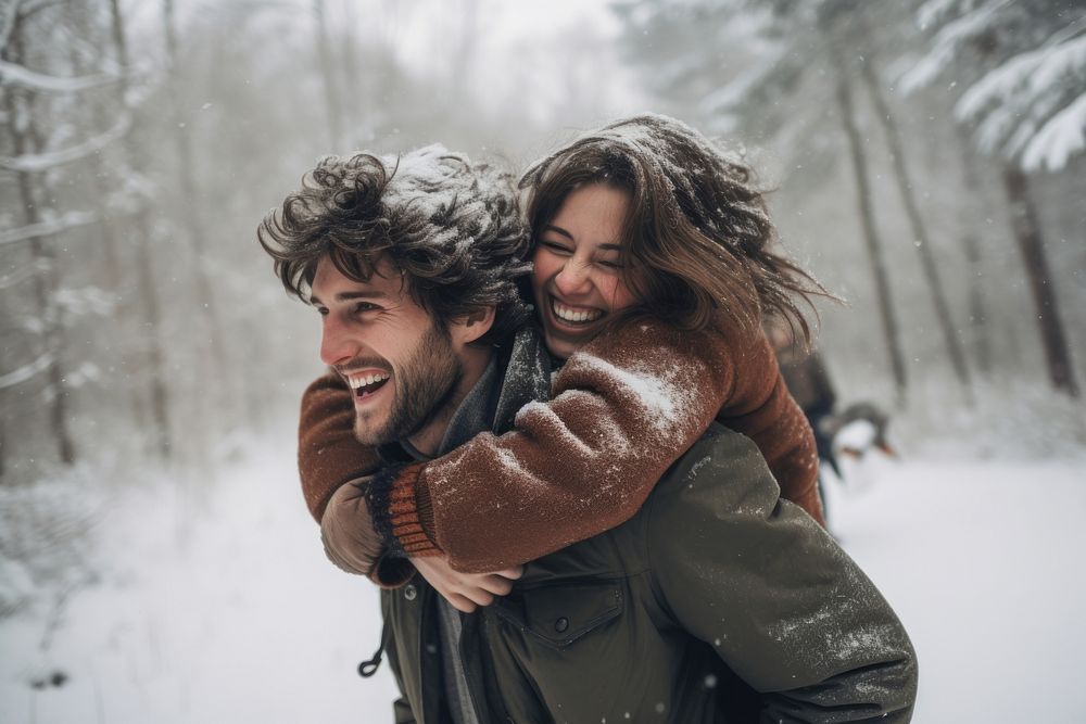 Snow laughing outdoors hugging. 