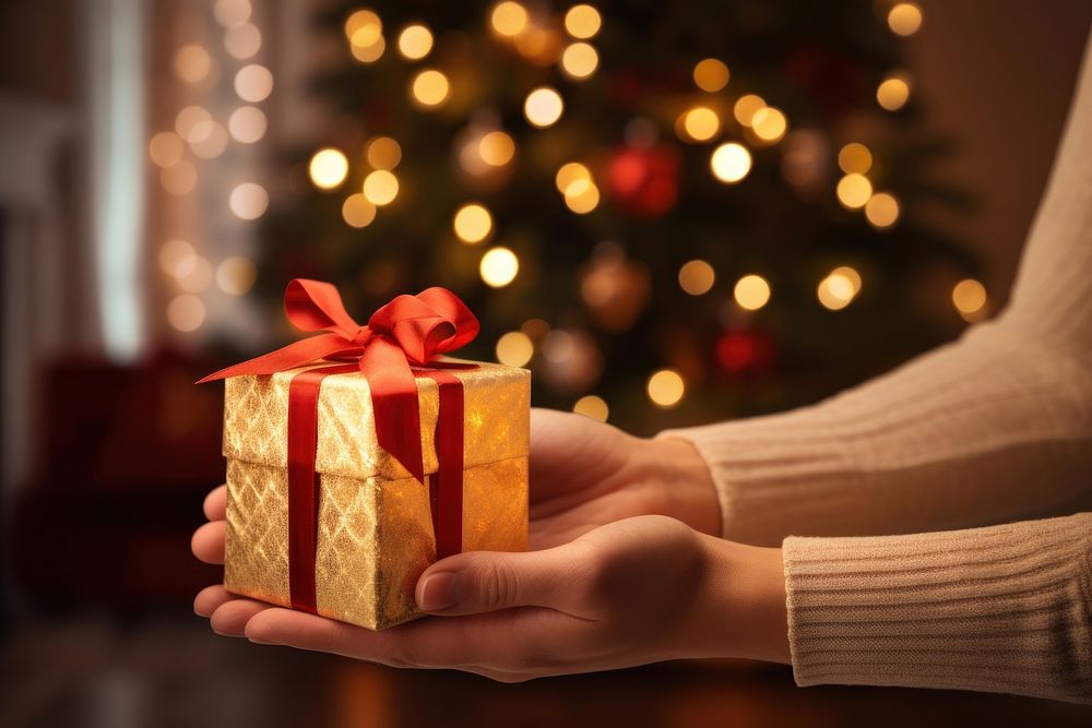 Christmas holding gift hand. AI generated Image by rawpixel.