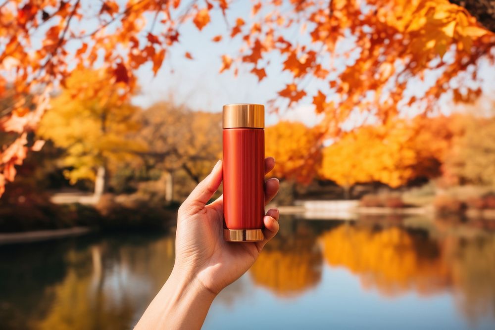 Autumn cosmetics holding bottle. 