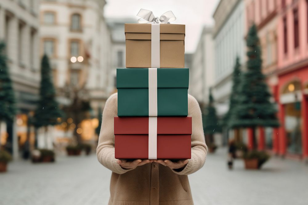 Woman holding stacked Christmas gift boxes