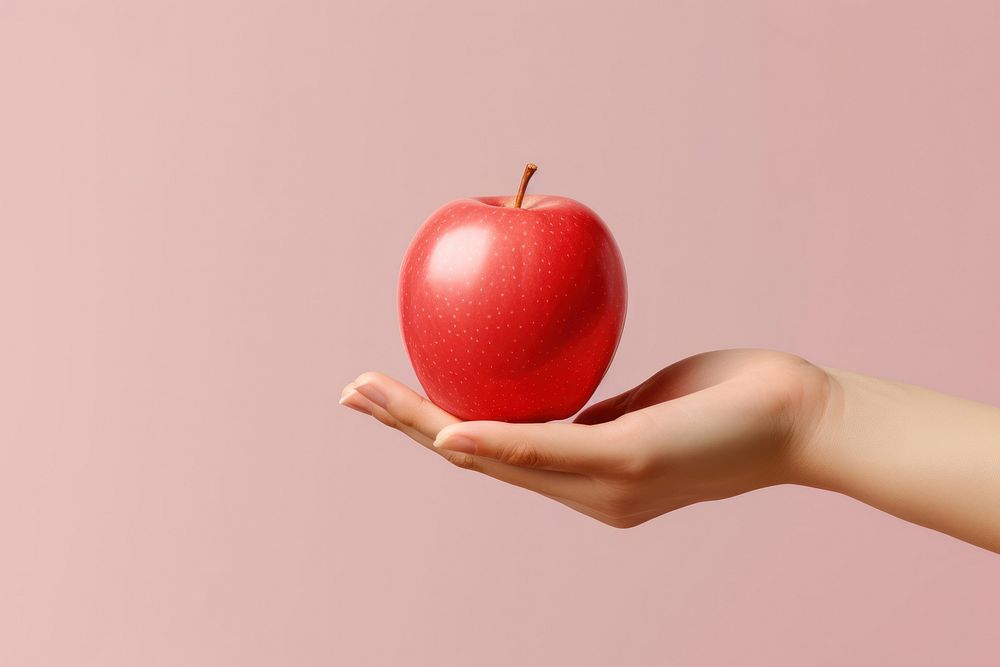 Apple holding fruit plant. 