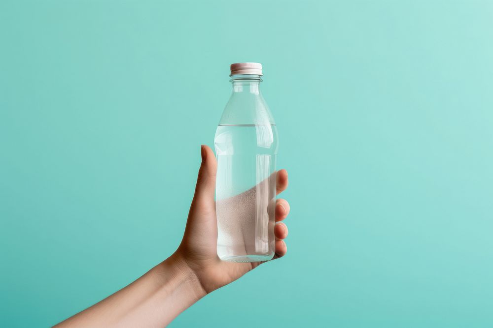 Bottle holding hand refreshment. AI generated Image by rawpixel.