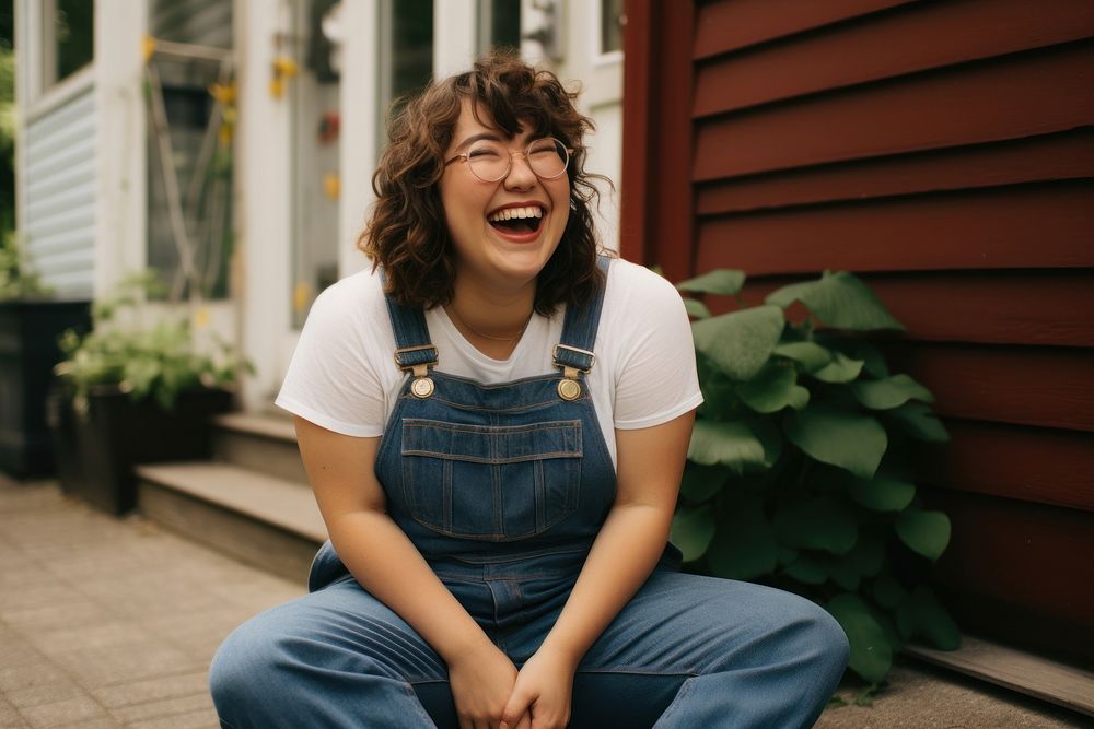 Laughing portrait outdoors sitting. AI generated Image by rawpixel.