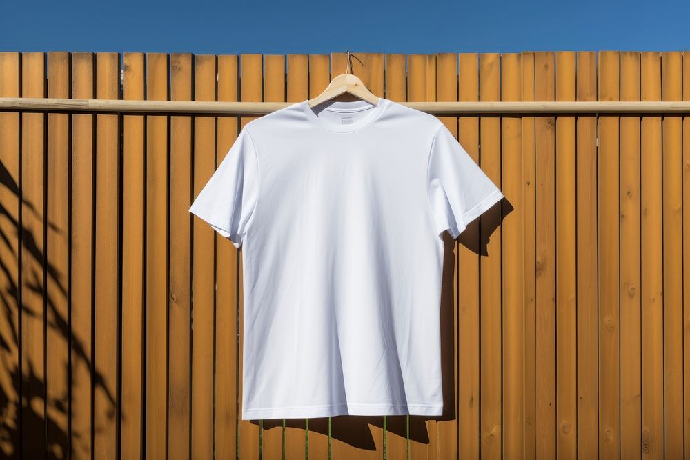 T-shirt sleeve white fence. 