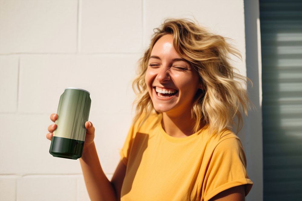 Happy woman holding soda can