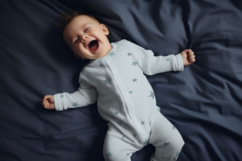 Cheerful baby in blue pajamas