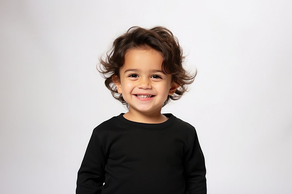 A male toddler smiling wearing a black long sleeve T-shirt portrait child smile. AI generated Image by rawpixel.