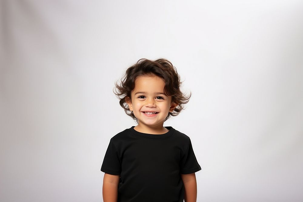 A male toddler smiling wearing a black long sleeve T-shirt portrait t-shirt child. AI generated Image by rawpixel.