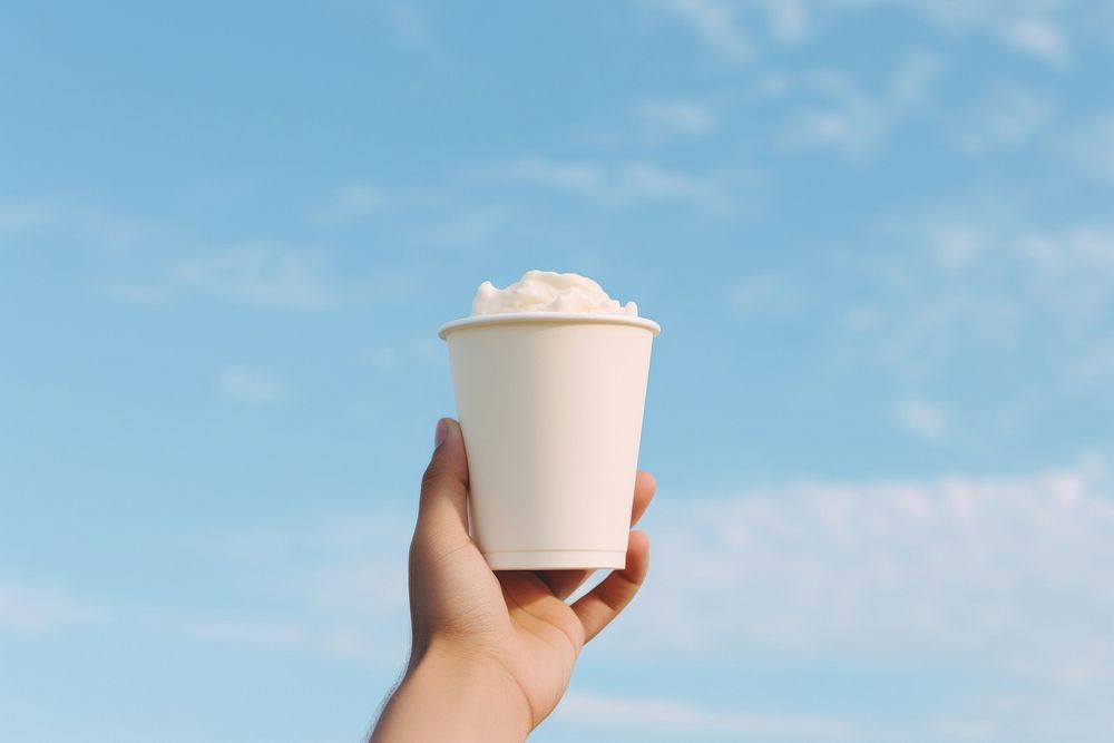 Cup holding cream food. AI generated Image by rawpixel.