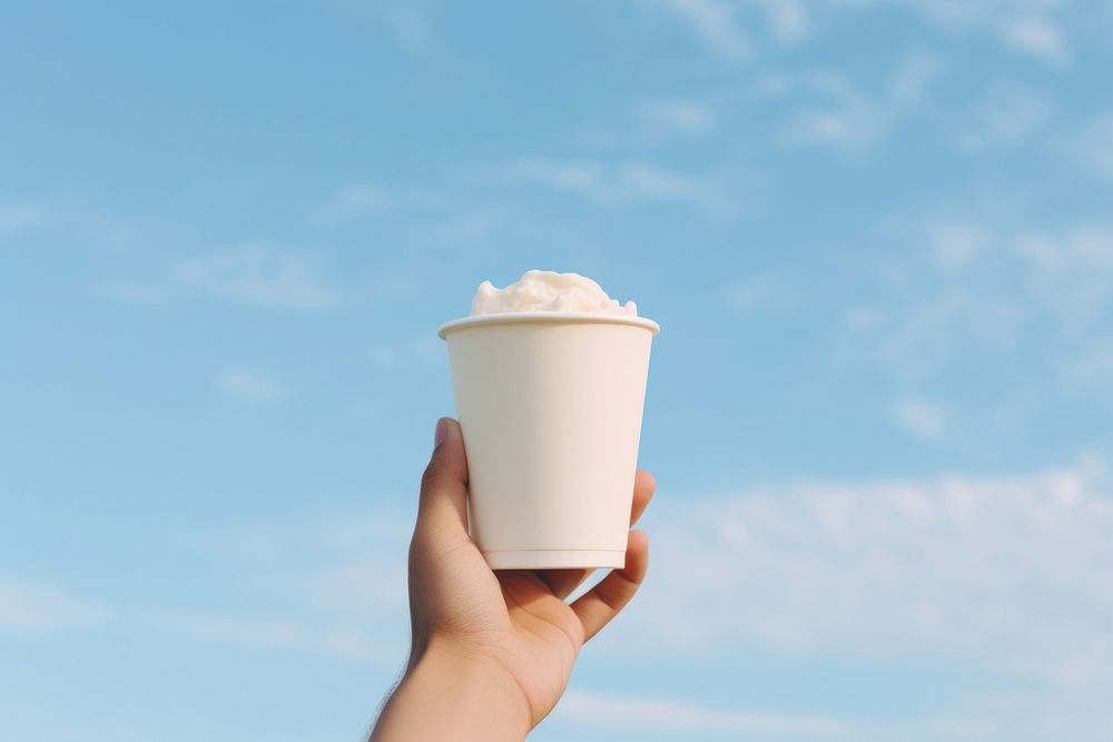 Cup holding cream food. 