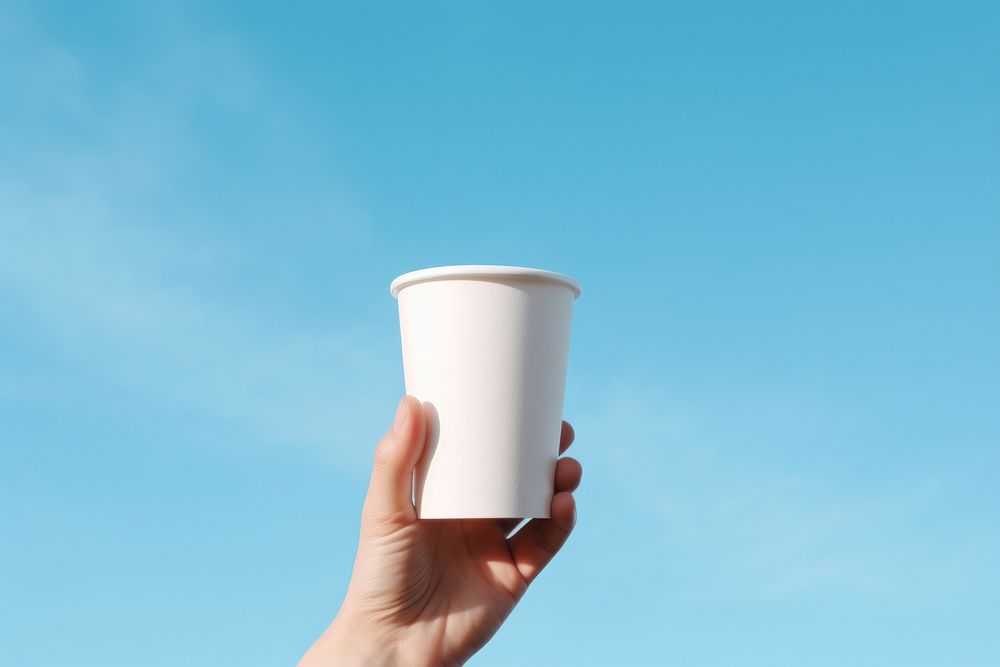 Coffee cup holding hand. AI generated Image by rawpixel.