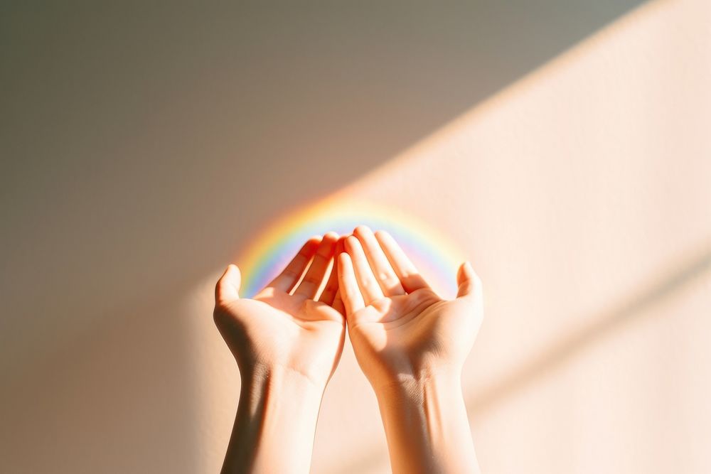 Hand holding rainbow finger. 