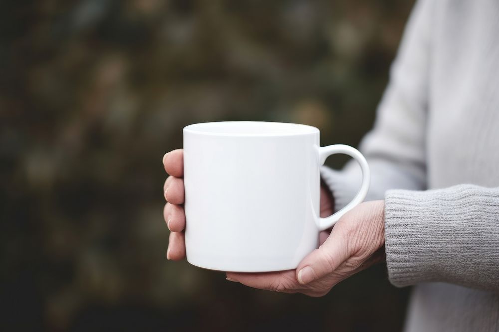 Mug holding coffee drink. 