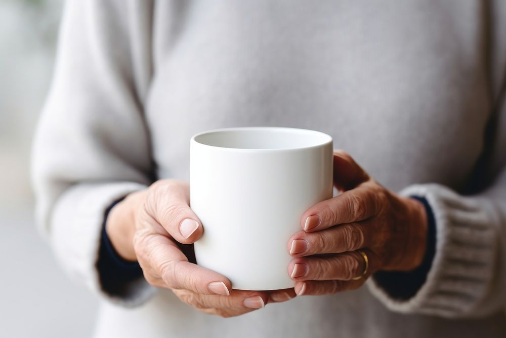 Mug holding coffee drink. 