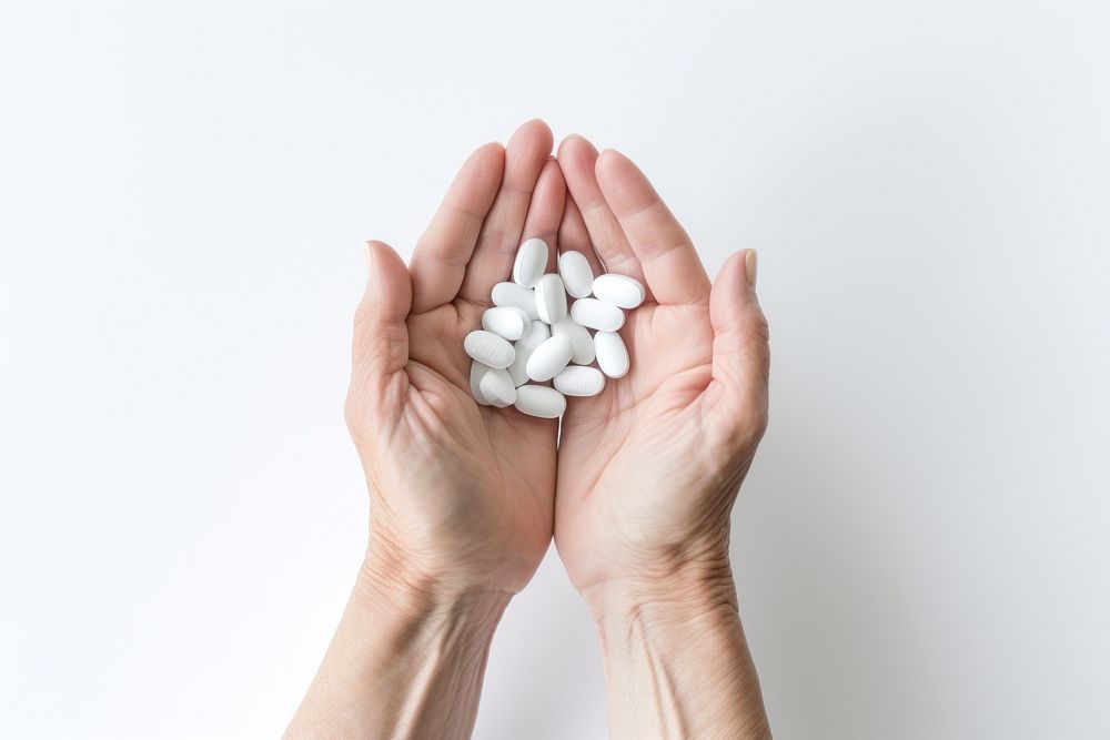 Medicine holding white pill. 