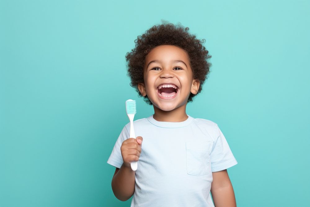 Toothbrush holding happy baby. 