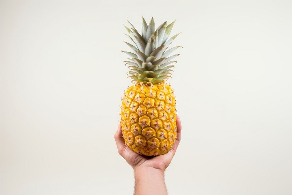 Pineapple holding fruit plant. AI generated Image by rawpixel.