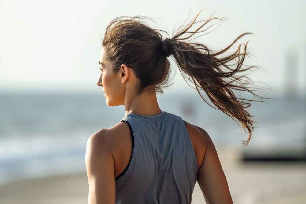 Ponytail hairstyle jogging beach. 