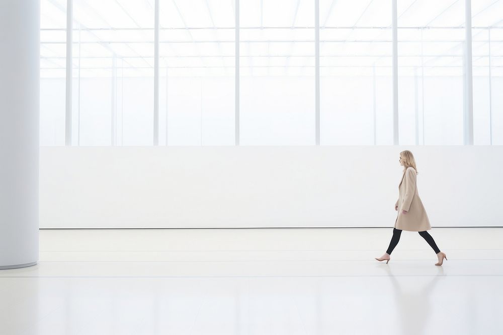 Defocused Woman Walking In large Exhibition Art Hall walking standing day. AI generated Image by rawpixel.