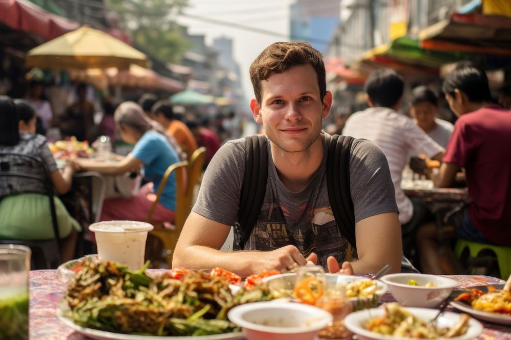 American man eating padthai food restaurant street. AI generated Image by rawpixel.