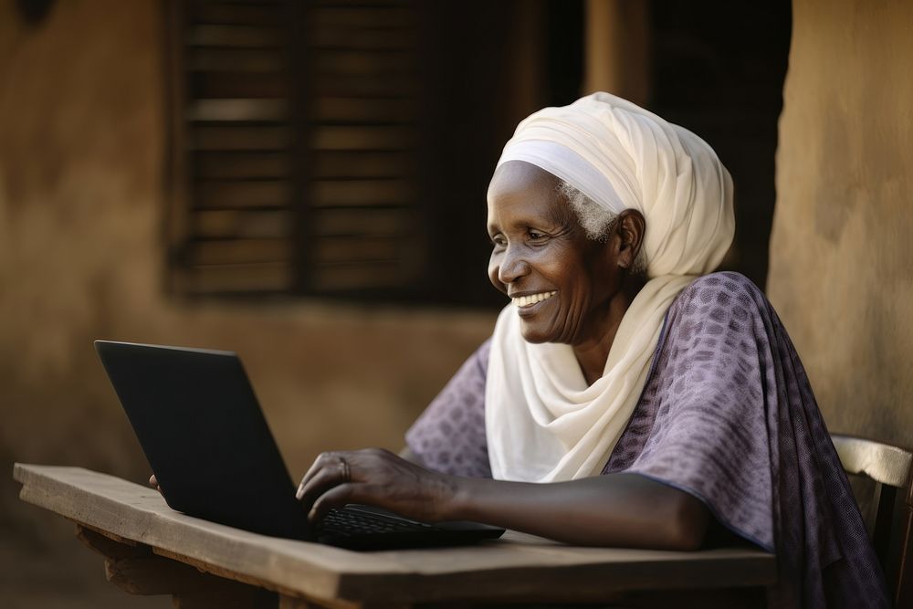 Senior african woman laptop computer sitting. AI generated Image by rawpixel.