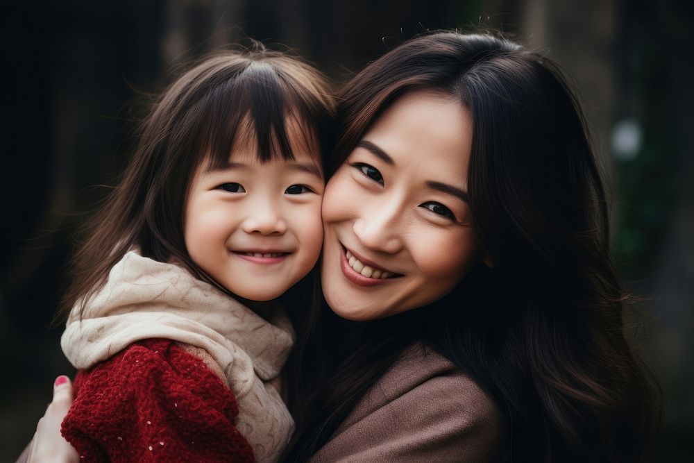 Asian daughter hugging mother child adult smile. 