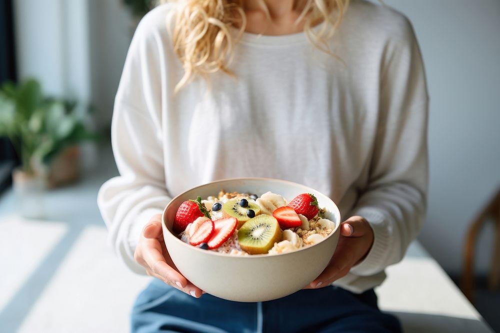 Woman eating a healthy bowl fruit adult. 