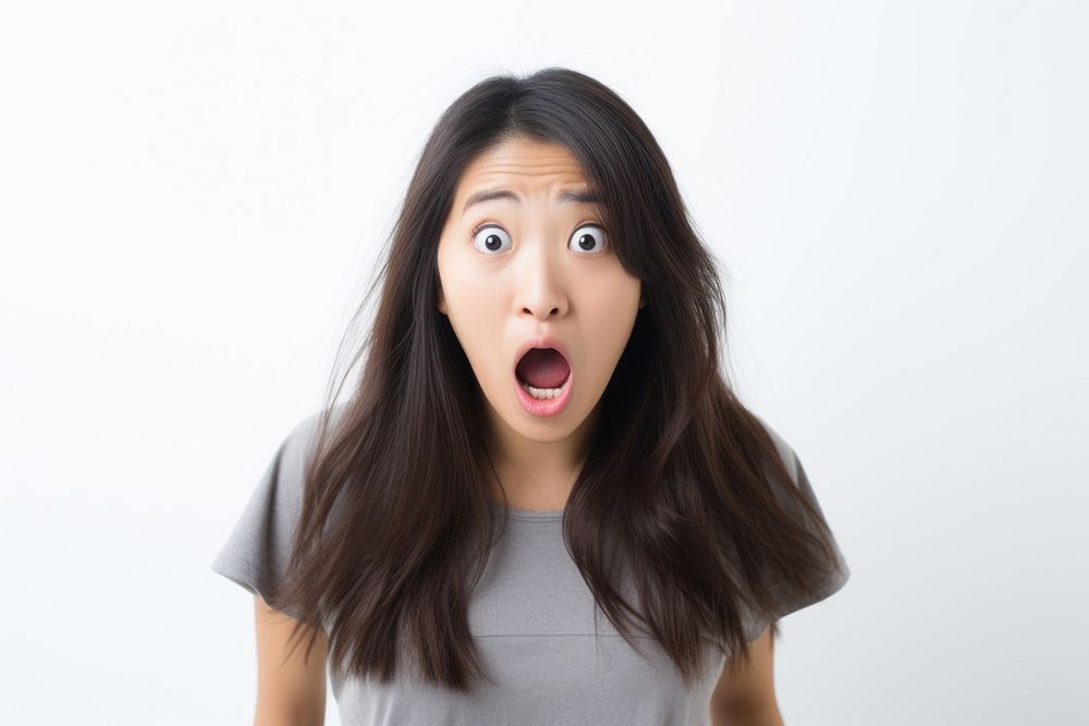 Asian girl getting frightened adult white background frustration. AI generated Image by rawpixel.