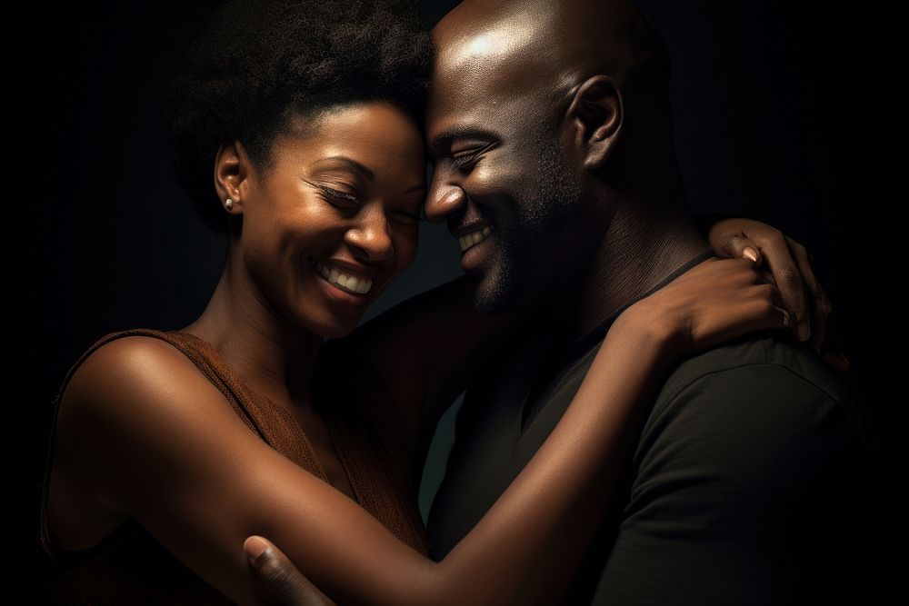 Black couple portrait hugging adult. 