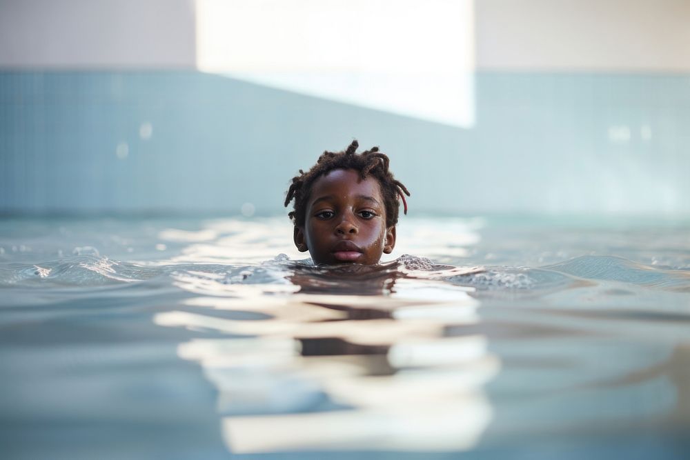 African american kid taking swimming lessons recreation sports medication. AI generated Image by rawpixel.