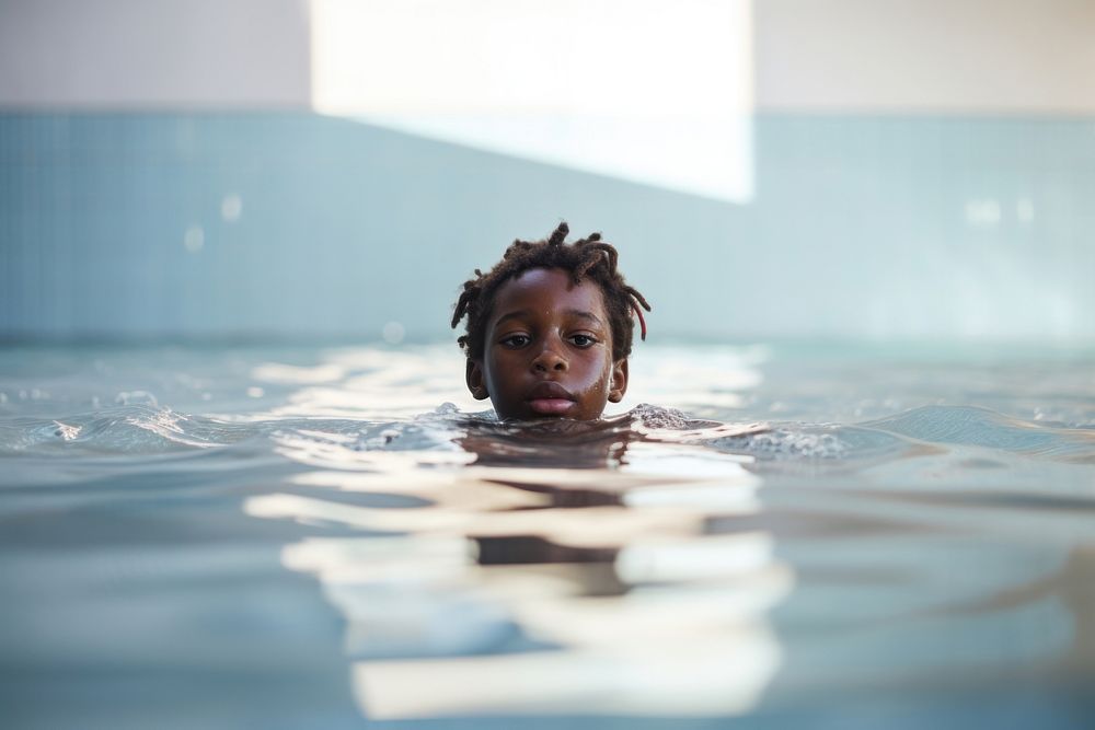 African american kid taking swimming lessons recreation sports medication. 