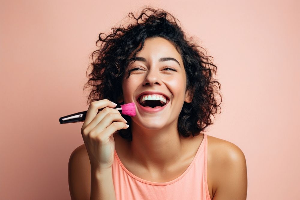 Woman applying mascara laughing happy microphone. 