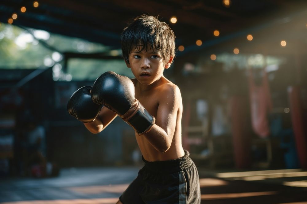 Thai boy practicng muay thai boxing punching sports. 