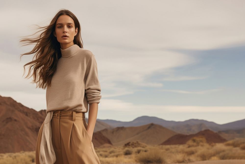 A woman standing wearing a minimal colorful outfit outdoors nature adult. 