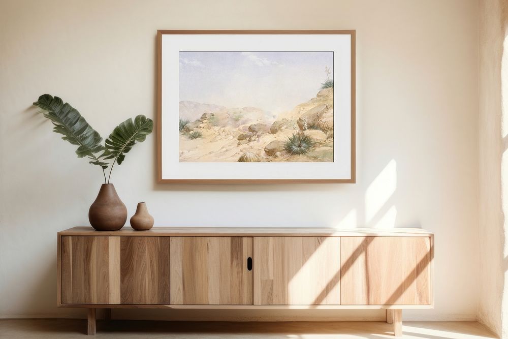 Wooden cupboard with landscape painting on a wall