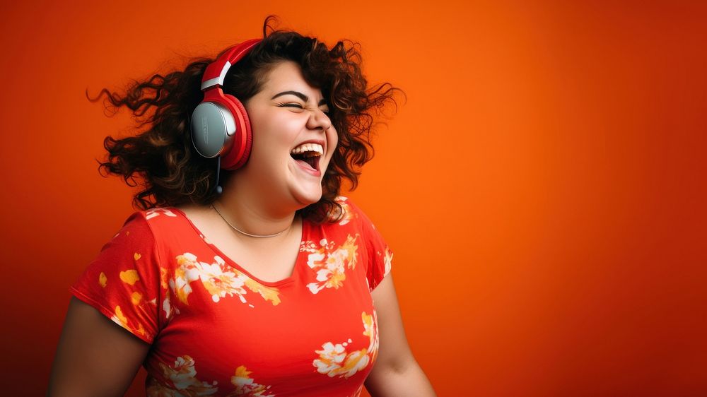 Woman wearing headphones laughing smiling music. AI generated Image by rawpixel.