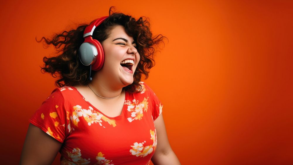 Woman wearing headphones laughing smiling music. 