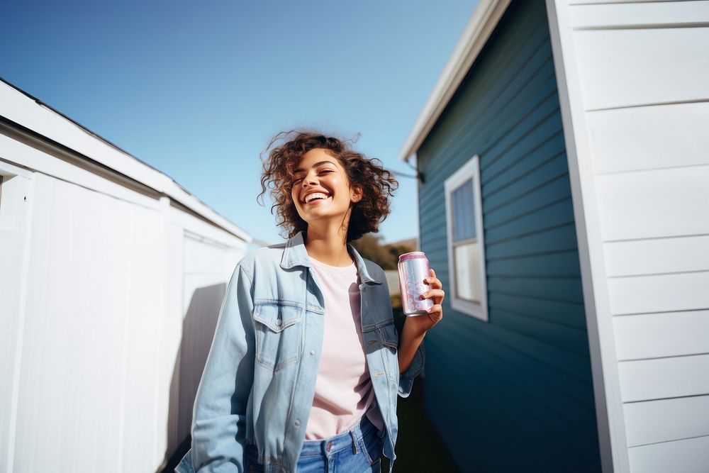 Portrait photo of a happy woman holding aluminum can looking at out side on minimal home. AI generated Image by rawpixel.