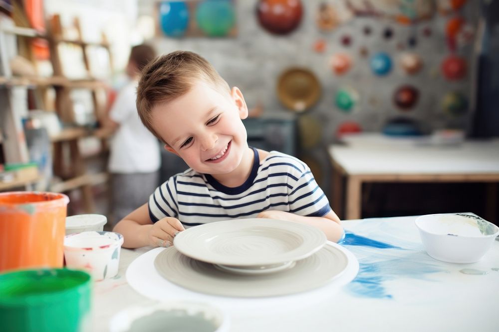Happy kid painting portrait table plate. AI generated Image by rawpixel.