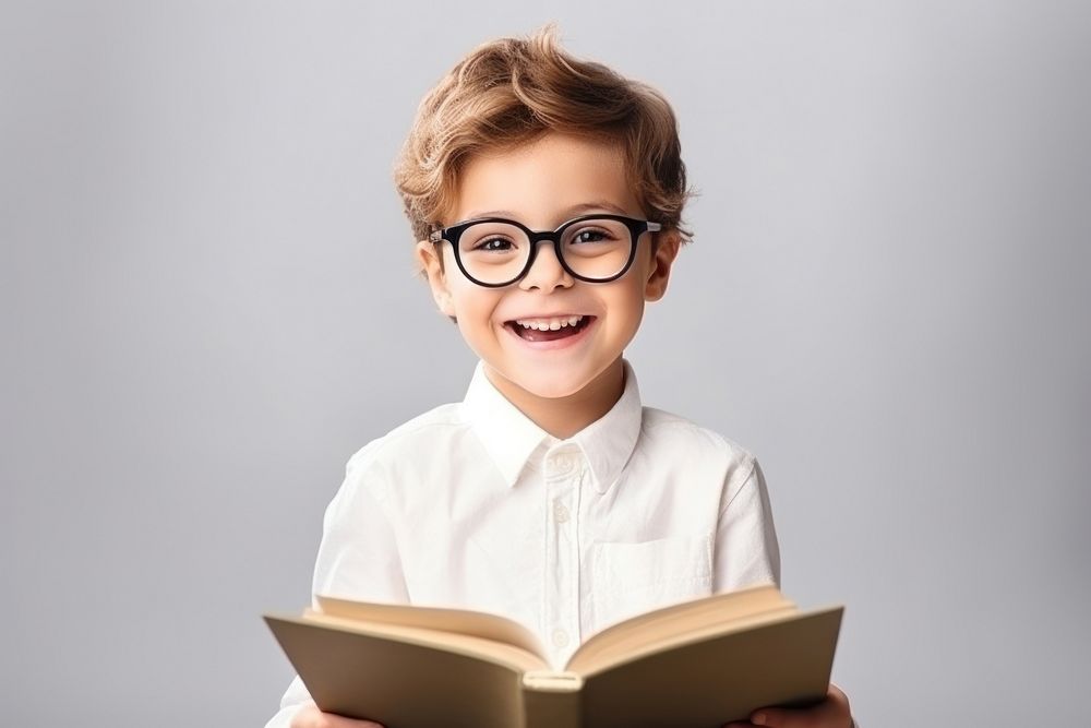 Kid boy wear glasses reading a book publication portrait smile. AI generated Image by rawpixel.