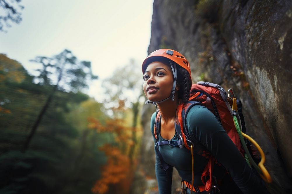 Photo of a african american female hiker go rock climbing. 