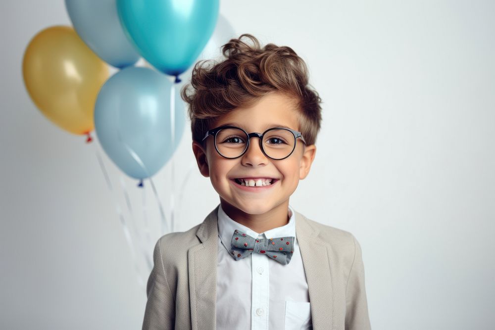 Little boy wearing glasses having a party birthday portrait balloon smile. AI generated Image by rawpixel.