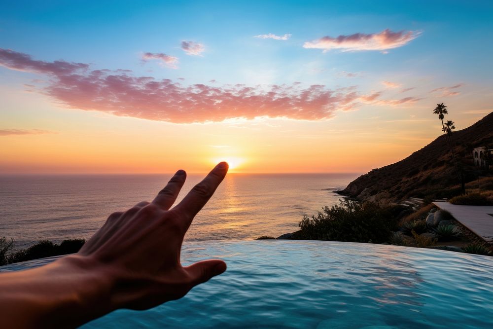 Malibu sunset hand outdoors horizon. AI generated Image by rawpixel.