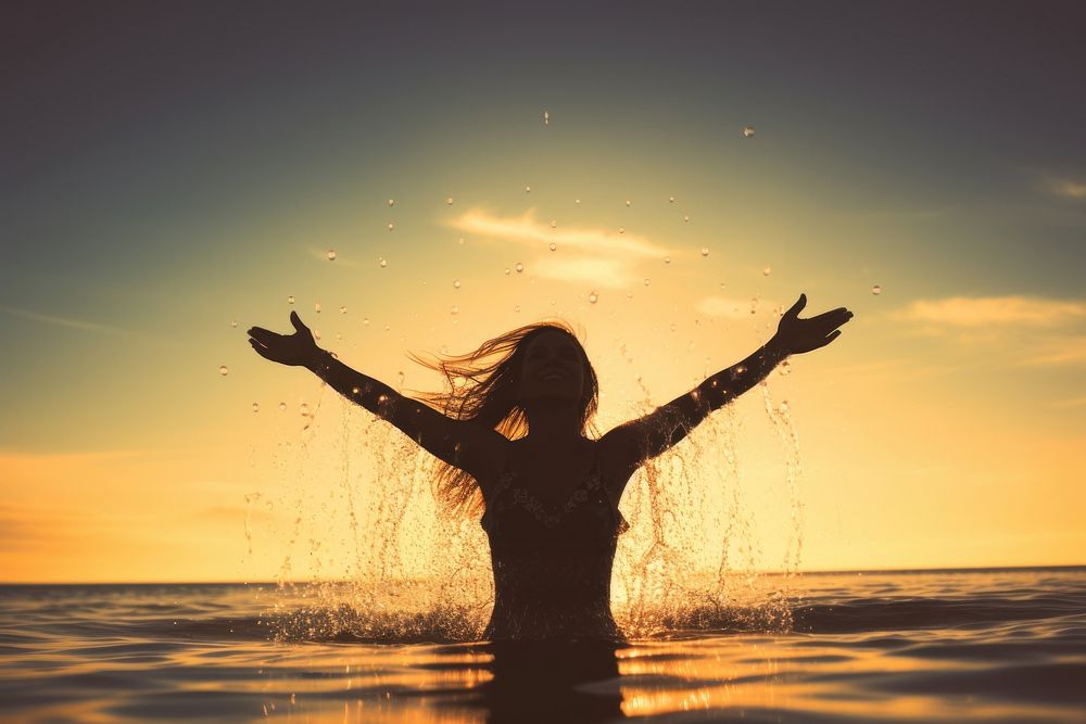 Happy woman silhouette splashing sunset. AI generated Image by rawpixel.